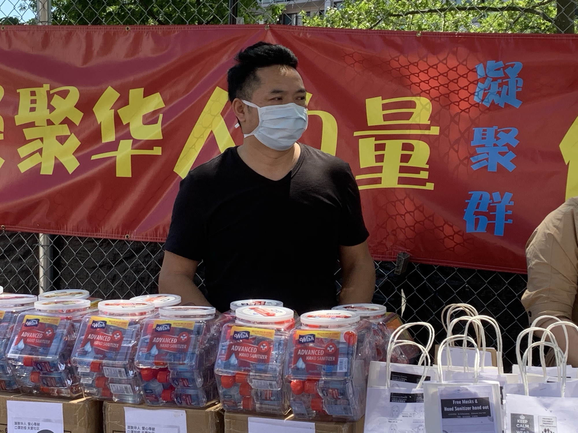 Photograph from the original interview: May 30: Distributing protective supplies and information in a Chinese community in New York.