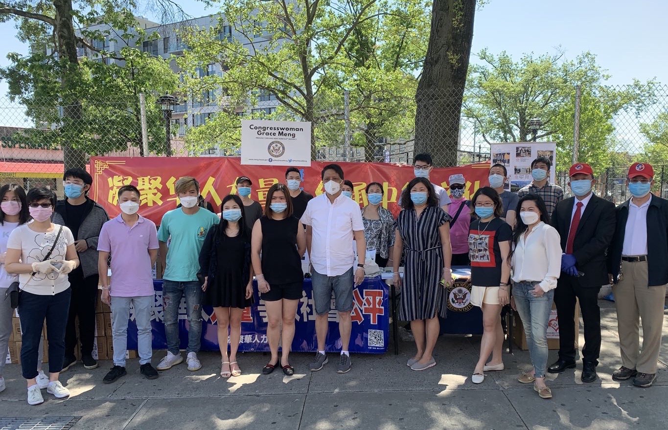 Photograph from the original interview: Chinese volunteers with Congresswoman Grace Meng, distributing protective supplies free of charge in the community.