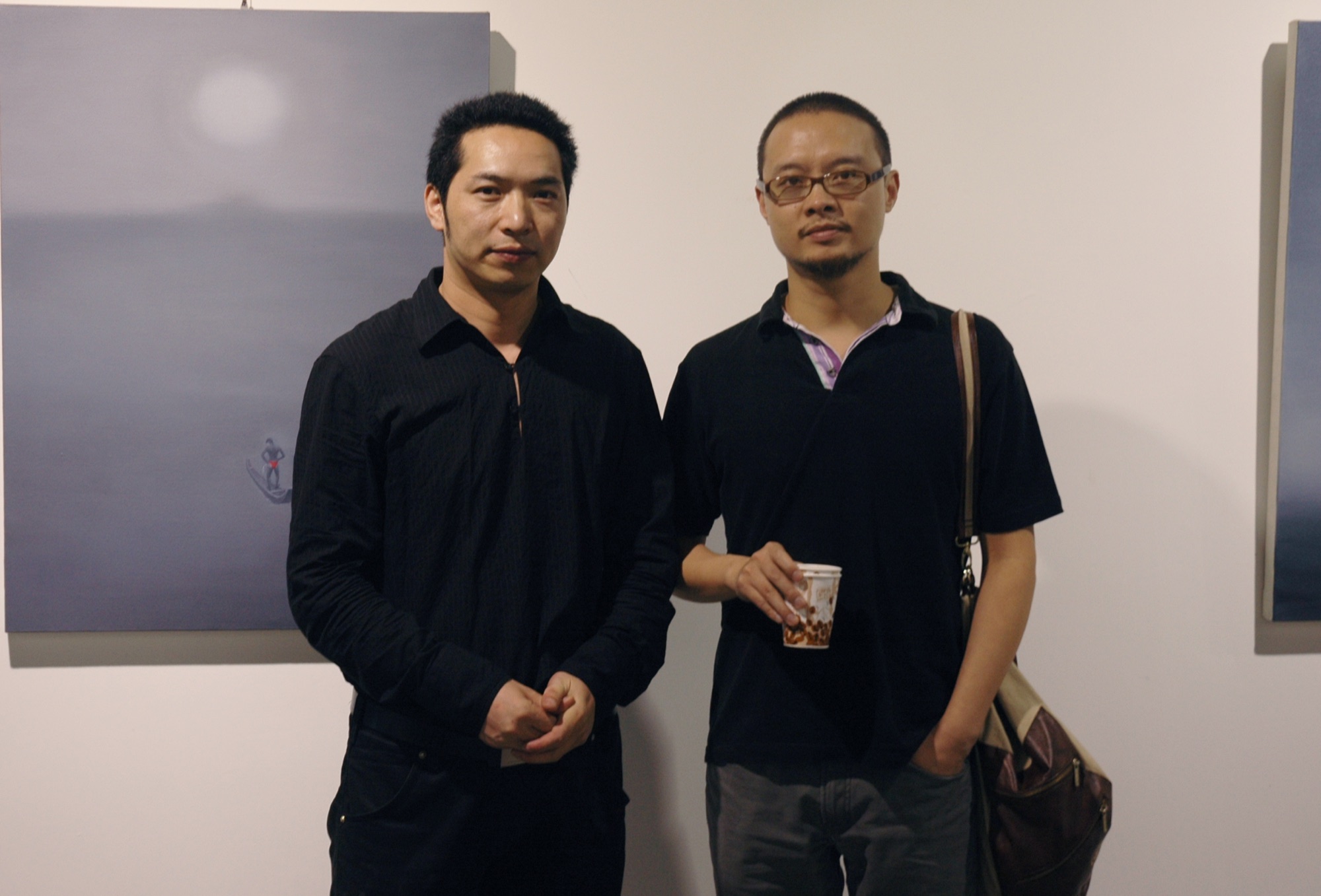 Two people posing in front of a painting at A Single Thread.